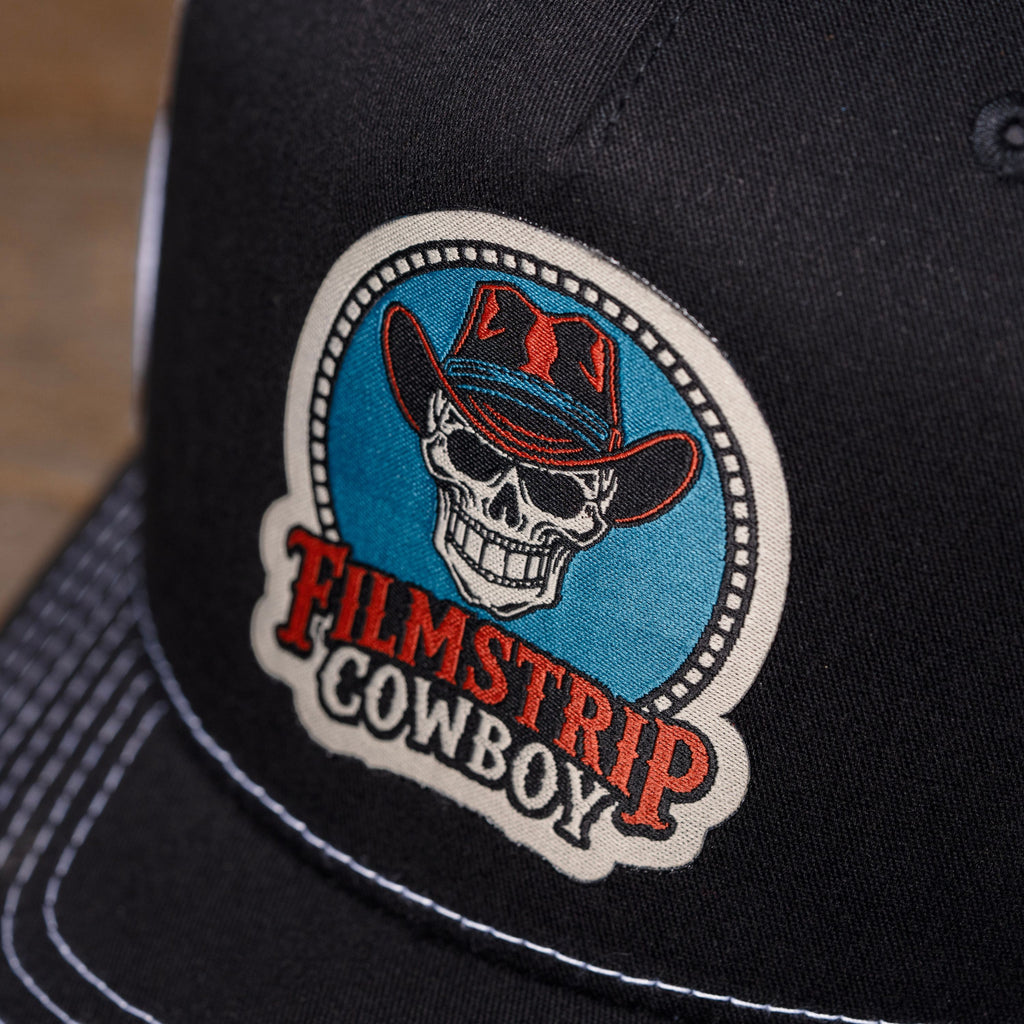 Filmstrip Cowboy™ Black Trucker Hat